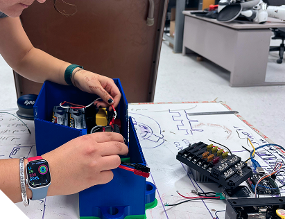 Hands working on rover electronics